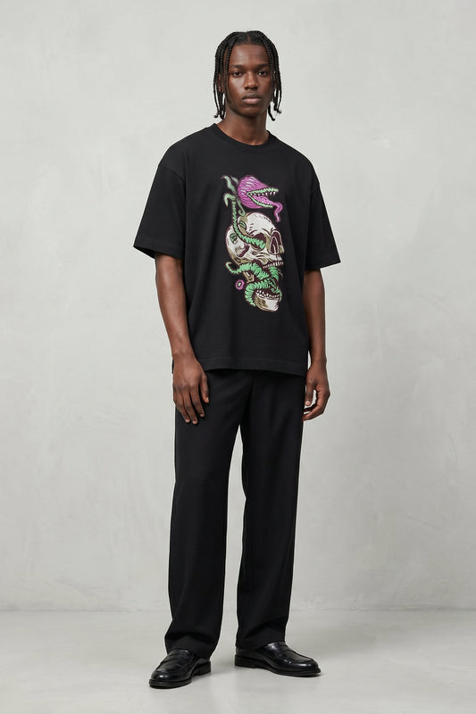 Person wearing a black t-shirt with a colorful graphic design on a plain background